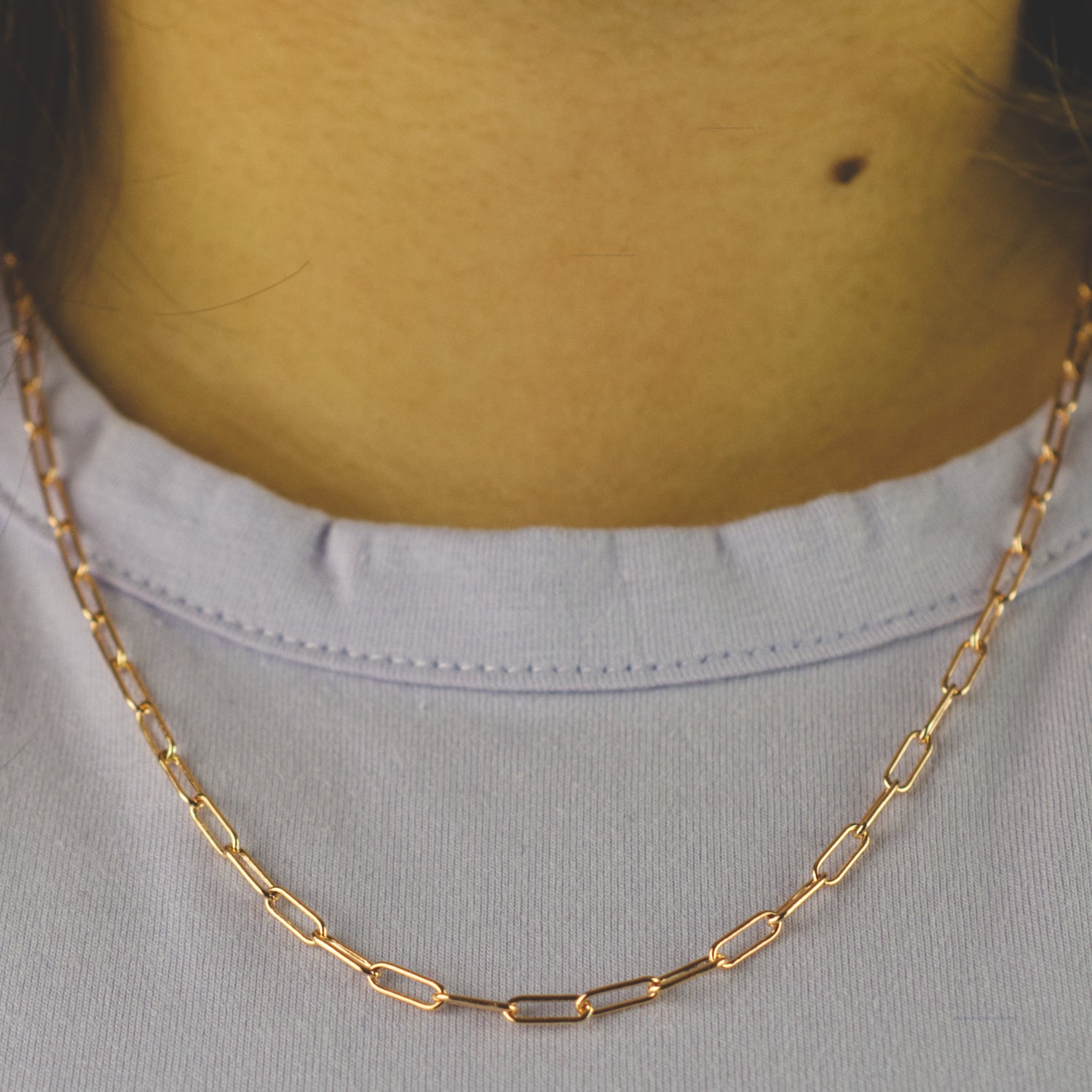 Woman wearing a 14K rose gold fill paperclip chain necklace with classic style (large) link size